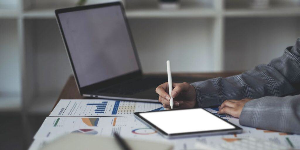 Un hombre de negocios escribiendo en una tableta con un bolígrafo.